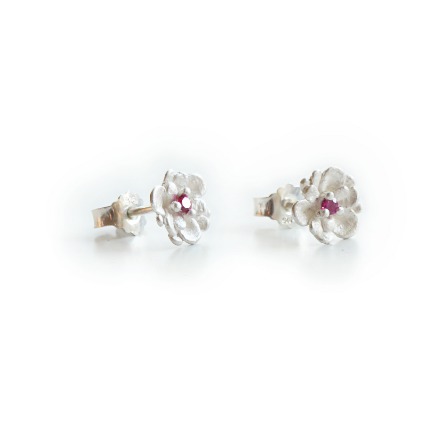 Pink sapphire floral stud earrings with three delicate pistil prongs, handcrafted in recycled sterling silver