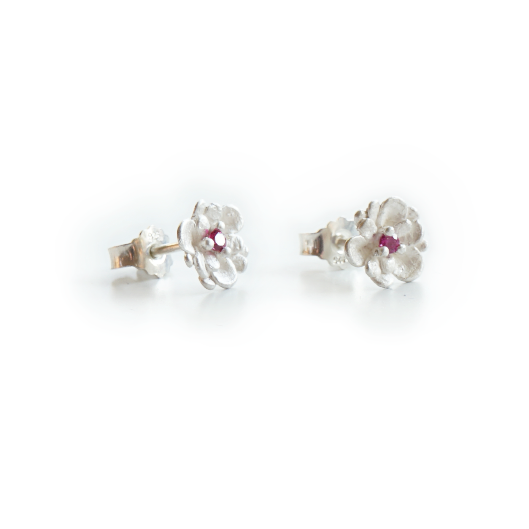 Pink sapphire floral stud earrings with three delicate pistil prongs, handcrafted in recycled sterling silver