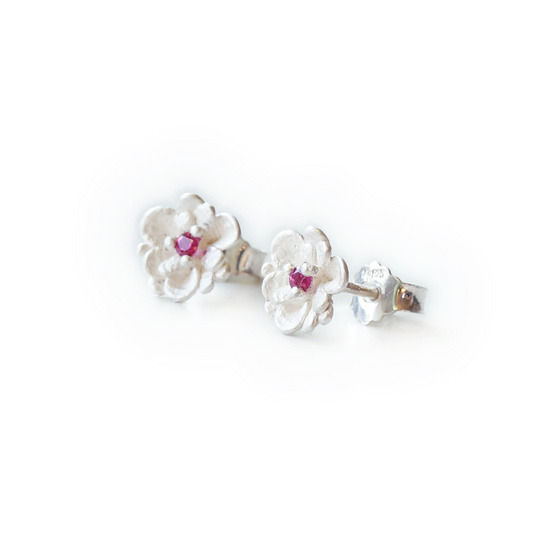 Handcrafted floral stud earrings in recycled 925 sterling silver, featuring a pink sapphire or ethical synthetic pink ruby, three-prong setting, botanical design